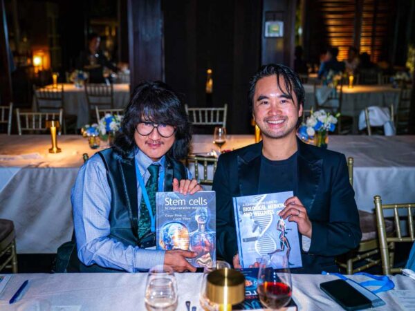 Prof. Mike Chan and Dr. Adrian Cheng at the We Are The World Global Summit 2025 Gala Dinner, holding two landmark publications in regenerative medicine and biological wellness. The conversation between science and investment leadership symbolises the Summit’s mission to unite global innovators shaping the future of health and longevity.