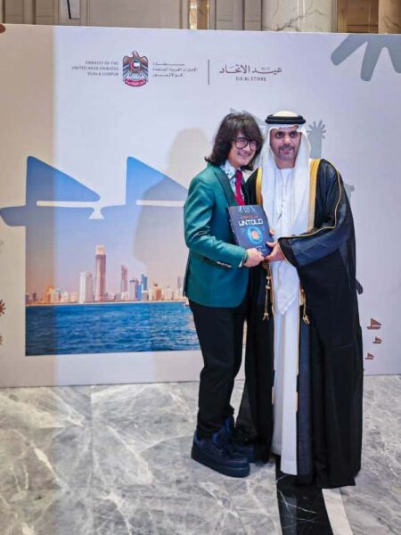 Prof. Mike Chan presents his stem cell and regenerative medicine books to the UAE ambassador during the National Day reception in Kuala Lumpur.