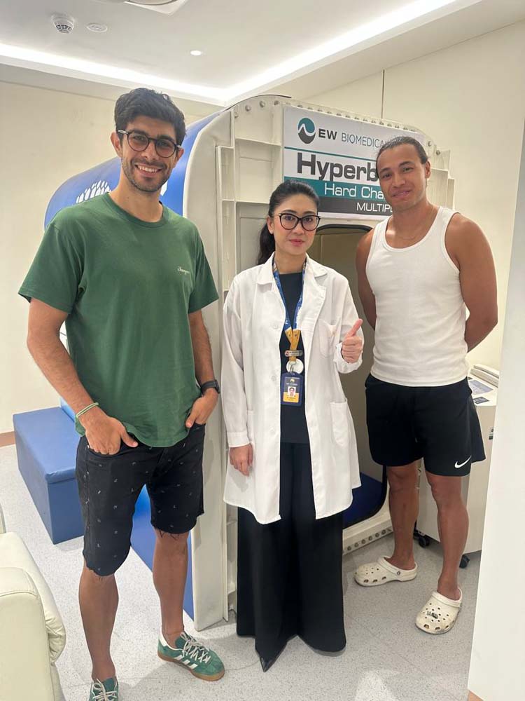 Dr. Natassia Sarah, European Wellness Sports Science Medical Manager, is pictured in the center with Jose Angel Alonso on the left and Dane Ingham on the right before their HBOT session.