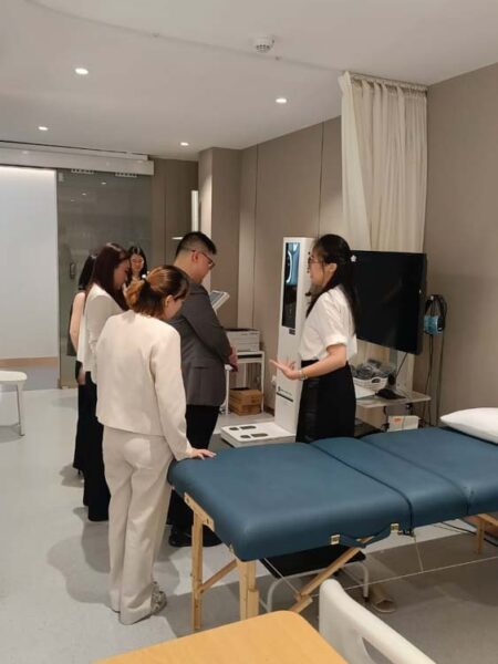 Representatives review equipment and center operations during the visit.
